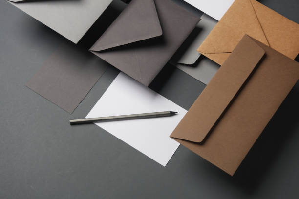 istock Floating envelopes and cards on dark gray background with shadow. Minimalism, modern business still life, creative layout 2042050538