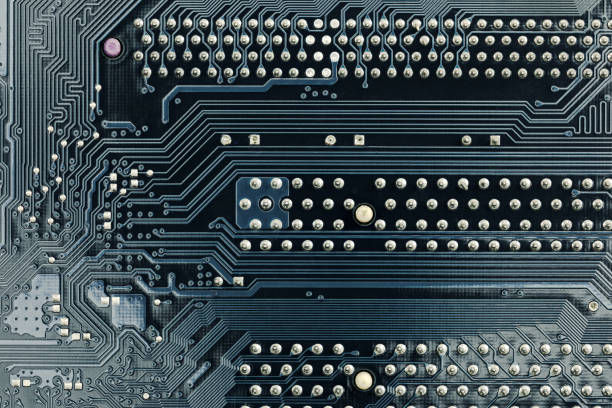 Close up of circuit board with microchips and other computer parts.