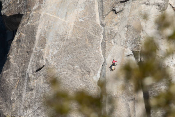 Man Rock Climbing the Granite Wall