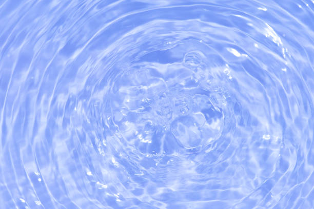 Waves on the beach. Blue sea wave. Blue water surface texture with ripples, splashes, and bubbles. Abstract summer banner background Water waves in sunlight with copy space cosmetic moisturizer.
