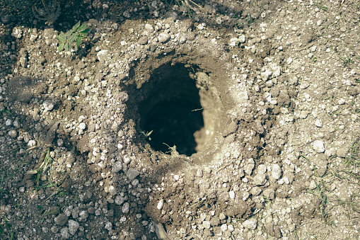 A hole in the ground that is dug into a hole. Top view