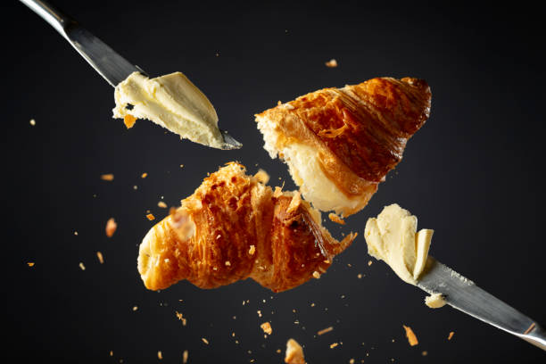 istock Fresh baked croissant and knifes with butter. 2042084441