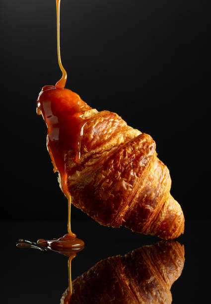 istock Fresh baked croissant with caramel sauce. 2042084442