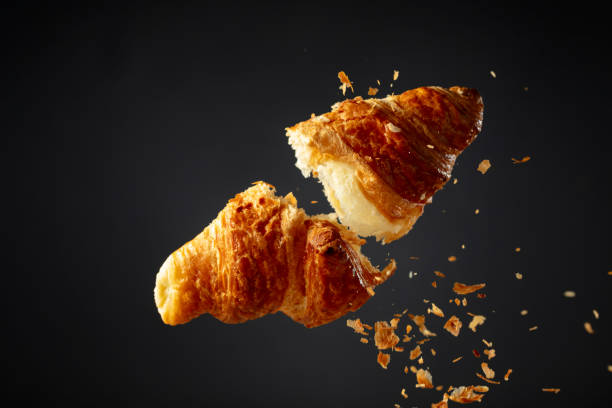 istock Croissant in air on a black background. 2042084446