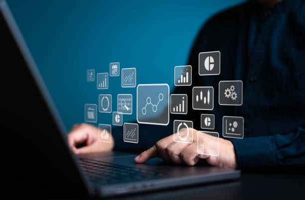 istock Analyst works on laptop computer to calculate KPI metrics reports with database connected. Data management and business analytics,  corporate strategy for finance, sales, operations, and marketing. 2042085723