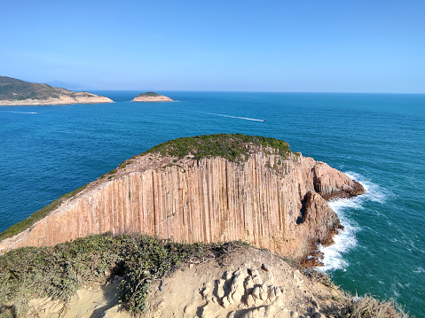 Hexagonal rock walls at Po Pin Chau, a stack island by High Island Reservoir East Dam on the South China sea. The area is famous for the rhyolitic rock formations which is part of Hong Kong Unesco Global Geopark.