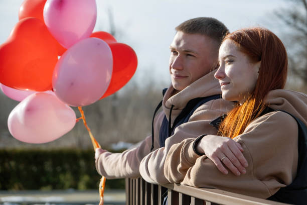 istock cheerful romantic couple dating and hugging outdoors, sky background 2042122322