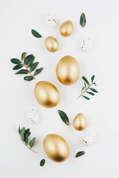istock Close-up top view of golden Easter eggs on white background, Happy Easter minimal concept 2042146983