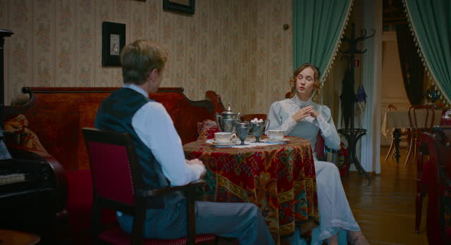young spouses drinking tea and chatting in vintage interior of 19th century, 4K, Prores