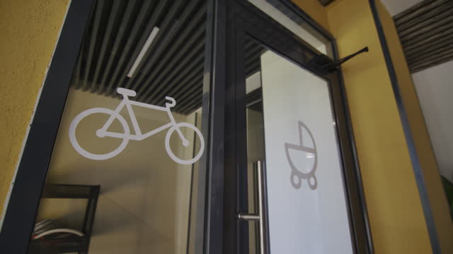 Markings on glass doors allow entry by bicycles and strollers