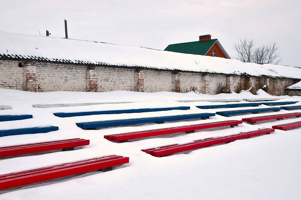 istock snow-covered benches in the old stadium 2042230301