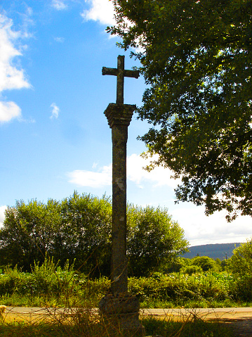 Cruceiro, ancient stone cross backlit, seen along camino de Santiago, near Santiago de Compostela, A Coruña  province, Galicia, Spain.