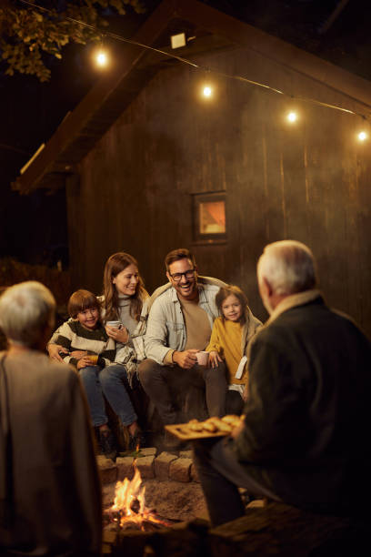 istock Happy extended family enjoying by the bonfire at night. 2042237621