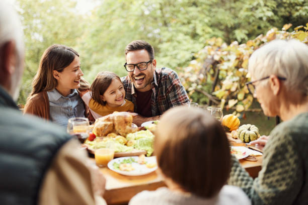 istock Happy extended family talking while enjoying in a meal on a patio. 2042239163