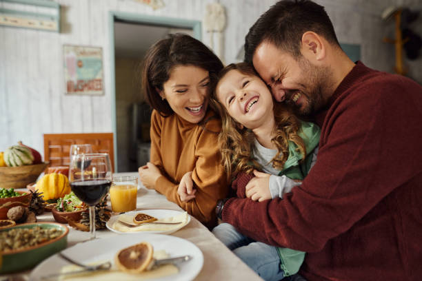 istock Young cheerful family enjoying in dining room. 2042252290