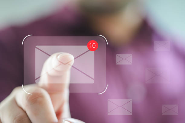 istock Man touches an envelope icon with a notification alert. Online communication concept. 2042252310