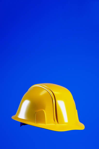 istock Hard hat for Labour Day concept. Yellow helmet isolated on blue vertical background, 3d render 2042253936