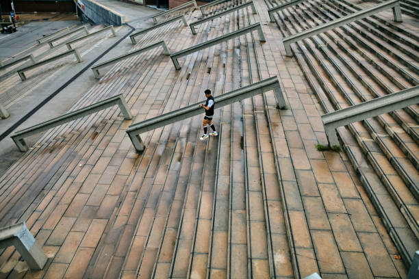 istock Male athlete moving down outdoor staircase 2042256027