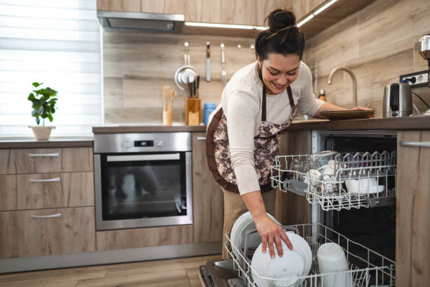 istock Woman loading the dishwasher in the kitchen 2042299993