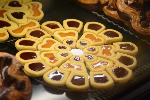A close-up of various tarts showcased in a glass cabinet
