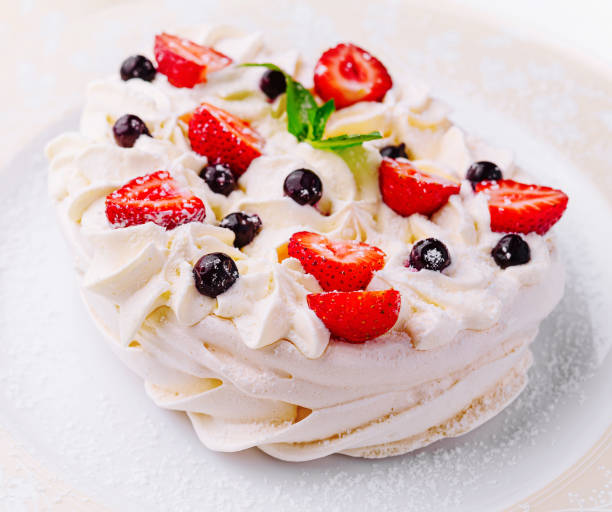 istock Pavlova cakes with cream and fresh berries on plate 2042304247