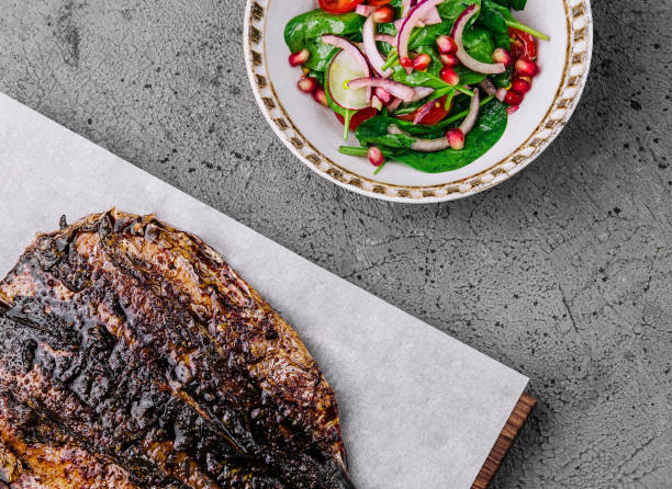 Grilled delicious fish with pomegranate salad