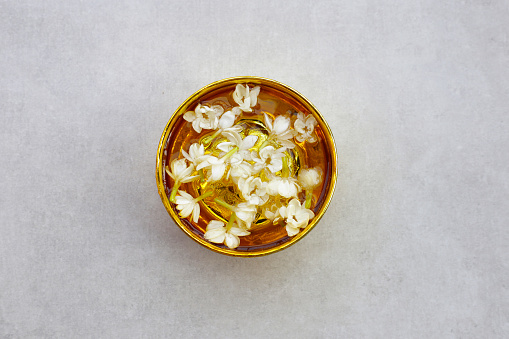 Water with jasmine flowel in golden bowl. Thai tradition, Songkran festival concept