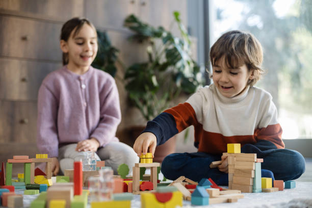 istock children playing with toy blocks at home together 2042328843