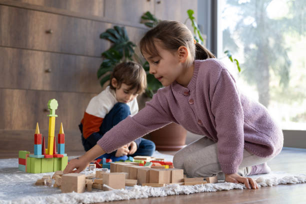 istock children playing with toy blocks at home together 2042329888