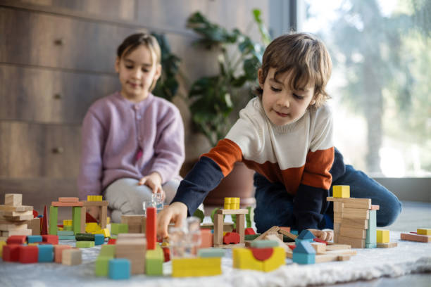 istock children playing with toy blocks at home together 2042331461
