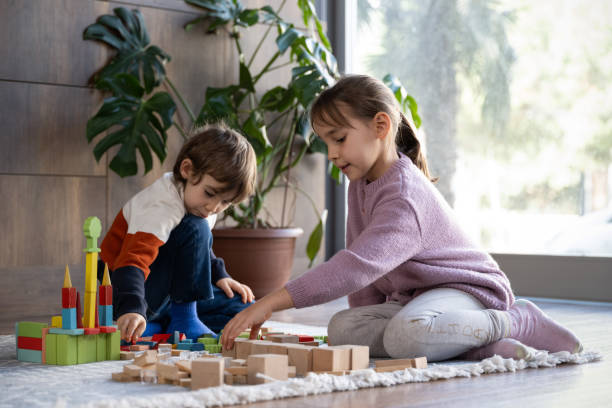 istock children playing with toy blocks at home together 2042334558