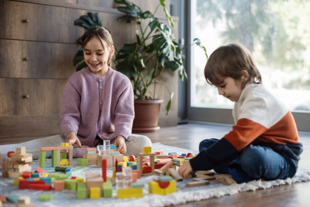 istock children playing with toy blocks at home together 2042335111