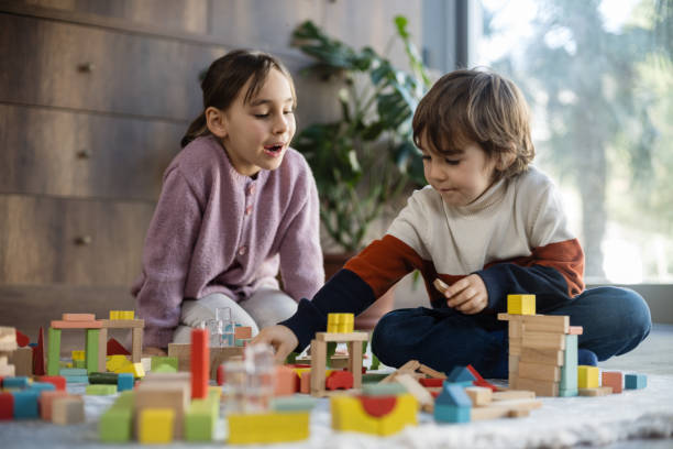 istock children playing with toy blocks at home together 2042336170