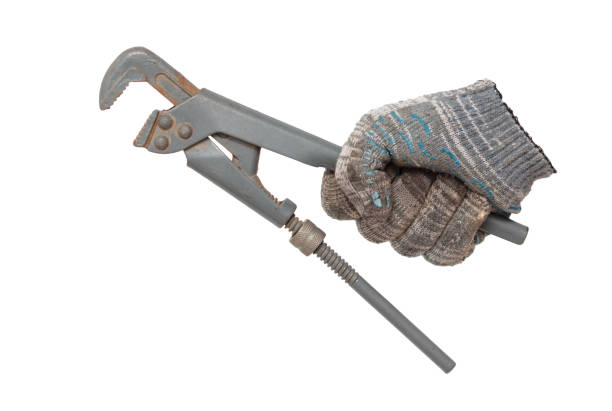 istock Plumber's hand in glove holding a pipe wrench isolated on white background 2042344219