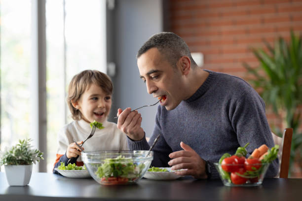 istock Father and son enjoying a healthy lunch together at home 2042347430