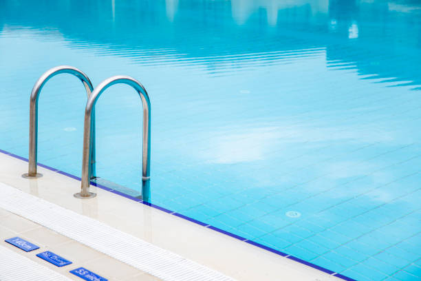istock Swimming pool with stair and blue water close-up with copy space 2042361464