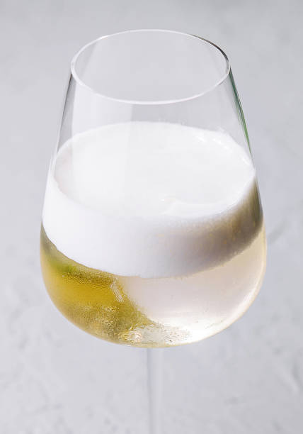 istock white cocktail with foam in a wine glass 2042363132