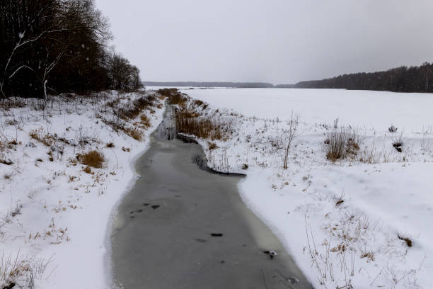 istock spots from falling snowflakes are visible on the river and sky 2042368328