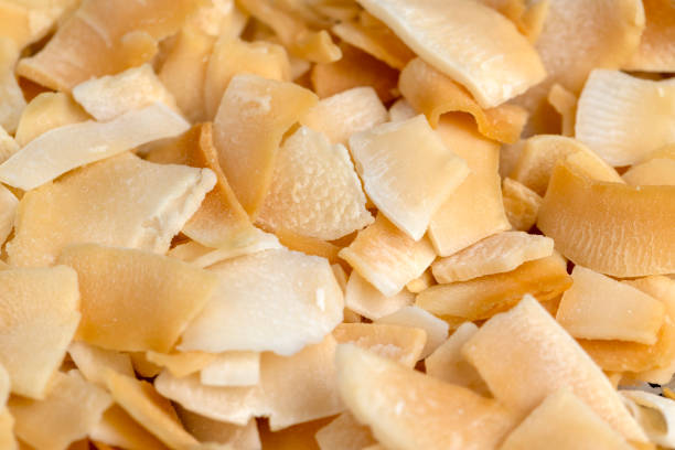 istock sweet orange and yellow coconut flakes fried in sugar 2042368882
