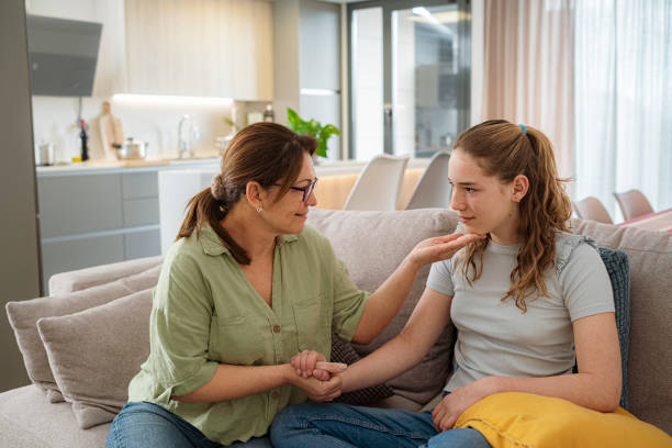 Loving mother talking to her teenager daughter stock photo