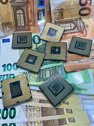 Close-up of computer microprocessors CPU on Euro banknotes. 100 Euro, 50 Euro, 200 Euro