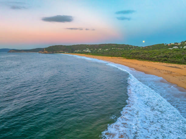 istock Sunrise by the sea and forest will full moon setting 2042399988