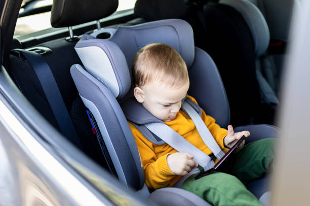 istock Little boy using smart phone in car interior while traveling. Childhood and technology concepts. 2042420921
