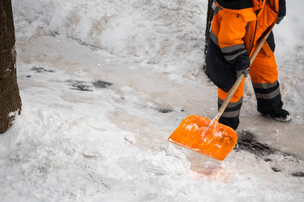 istock A man with a snow shovel cleans sidewalks in winter. 2042474378