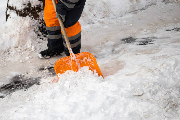 istock A man with a snow shovel cleans sidewalks in winter. 2042474380