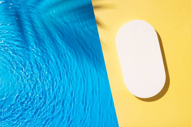 istock Mock up podium or pedestal flat lay on yellow background with blue water waves. 2042476100