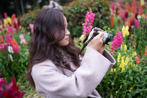 Female tourist taking photos of flowers