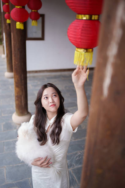 woman touching lantern with hand