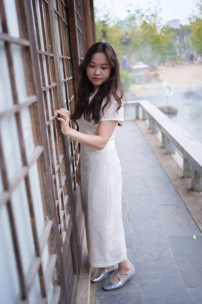 istock Asian woman standing by the wall 2042495501