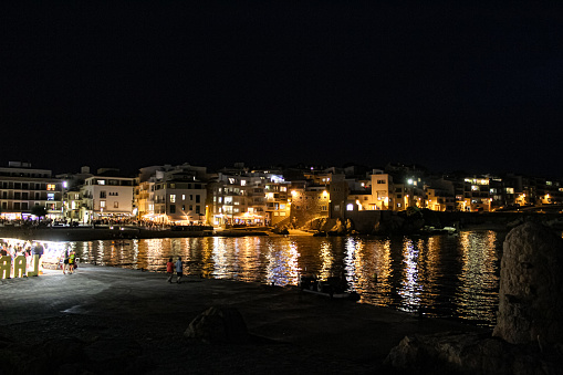 Coastal town at night with lights on